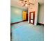 A room with light blue walls, bright ceiling fan, wood trim, and closet with mirror doors at 1806 Union St, Columbus, IN 47201