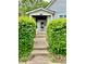 Charming home featuring a walkway framed by lush greenery, leading to a welcoming front porch at 1806 Union St, Columbus, IN 47201