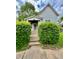 Charming home featuring a walkway framed by lush greenery, leading to a welcoming front porch at 1806 Union St, Columbus, IN 47201