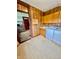 Laundry room featuring wood-paneled walls, cabinets, and washer-dryer connections conveniently located near the kitchen at 1806 Union St, Columbus, IN 47201