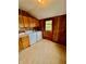 Practical laundry room with wood-paneled walls, ample cabinet space, and washer/dryer hookups at 1806 Union St, Columbus, IN 47201