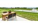 A patio set overlooks an expansive lawn with a pond and water feature in a community common area at 1829 James Pierce Dr, Shelbyville, IN 46176