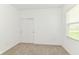 Clean bedroom featuring neutral carpet, white walls, and a closet with bi-fold doors at 1829 James Pierce Dr, Shelbyville, IN 46176