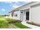 Inviting single-story home entrance with a walkway, black front door, and a view of a pond with a fountain at 1829 James Pierce Dr, Shelbyville, IN 46176