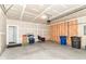 Two-car garage featuring concrete floors, bare drywall, and a garage door with mechanical opener at 1829 James Pierce Dr, Shelbyville, IN 46176
