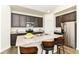 Kitchen showcasing granite countertops, stainless steel appliances, dark cabinets, and a functional island at 1829 James Pierce Dr, Shelbyville, IN 46176