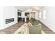 Open-concept layout featuring a fireplace, wood floors, kitchen, and living space with two armchairs at 1829 James Pierce Dr, Shelbyville, IN 46176