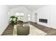 Cozy living room featuring wood floors, a modern fireplace, two green armchairs, and neutral wall paint at 1829 James Pierce Dr, Shelbyville, IN 46176