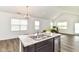 Open living space with vaulted ceilings, island seating, modern light fixture, and lots of natural light at 1829 James Pierce Dr, Shelbyville, IN 46176