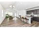 Open-concept living space with vaulted ceilings, wood floors, and a kitchen island with bar seating at 1829 James Pierce Dr, Shelbyville, IN 46176