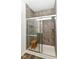 Tiled shower with glass door and built-in bench at 1829 James Pierce Dr, Shelbyville, IN 46176