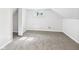 Bright bedroom featuring neutral carpet, a window and an open closet space at 225 S Carthage Rd, Charlottesville, IN 46117