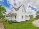 Beautiful exterior view with lush lawn, showcasing the side yard, and well maintained landscaping at 225 S Carthage Rd, Charlottesville, IN 46117