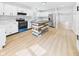 Modern kitchen with white cabinets, stainless steel appliances, and unique island at 225 S Carthage Rd, Charlottesville, IN 46117