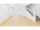 Bright living room with light flooring, neutral walls, and staircase to upper level at 225 S Carthage Rd, Charlottesville, IN 46117