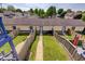 View of a backyard row of townhomes with a private fenced yard and a concrete walkway to the front door at 2260 Central Ave, Indianapolis, IN 46205