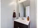 Bathroom featuring a single vanity and sink with a decorative mirror and fixtures at 2260 Central Ave, Indianapolis, IN 46205