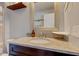 Bathroom with dark wood vanity, granite countertop, framed mirror, and convenient corner shelf at 2260 Central Ave, Indianapolis, IN 46205