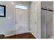 Bright entryway featuring a white door, hardwood floors, and a coat rack, offering a welcoming entrance at 2260 Central Ave, Indianapolis, IN 46205