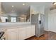 Open kitchen area with stainless steel refrigerator and view of the living room at 2260 Central Ave, Indianapolis, IN 46205