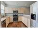 Well-lit kitchen with stainless steel appliances, light-colored cabinets, and wood flooring at 2260 Central Ave, Indianapolis, IN 46205