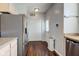 Kitchen features a stainless steel refrigerator, wooden floors, and access to the backyard at 2260 Central Ave, Indianapolis, IN 46205