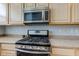The kitchen showcases stainless steel appliances, including a microwave and stove at 2260 Central Ave, Indianapolis, IN 46205