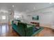 Inviting living room with modern decor, featuring a comfortable green sofa, hardwood floors, and ample natural light at 2260 Central Ave, Indianapolis, IN 46205