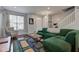 Inviting living room with modern decor, featuring a comfortable green sofa, hardwood floors, and ample natural light at 2260 Central Ave, Indianapolis, IN 46205