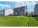Backyard features a well-maintained lawn, a gray house and black chain link fence at 3016 Gibbert Ln, Westfield, IN 46074
