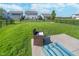 Grassy backyard with patio set near manicured lawn and dark chain link fence at 3016 Gibbert Ln, Westfield, IN 46074