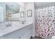 Bathroom featuring double sinks, a large mirror, and a floral shower curtain at 3016 Gibbert Ln, Westfield, IN 46074