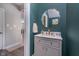Stylish powder room with a modern mirror, gold hardware, and beautiful green accent wall at 3016 Gibbert Ln, Westfield, IN 46074
