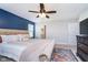 Comfortable bedroom featuring a plush bed, accent wall, ceiling fan, and natural light at 3016 Gibbert Ln, Westfield, IN 46074