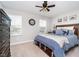 Bedroom with a ceiling fan, clock, and a large window showcasing neighborhood views at 3016 Gibbert Ln, Westfield, IN 46074