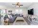 Comfortable living room featuring a sectional sofa, area rug, and ceiling fan at 3016 Gibbert Ln, Westfield, IN 46074