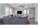 Spacious living room featuring a plush sofa, ceiling fan, and plenty of natural light at 3016 Gibbert Ln, Westfield, IN 46074