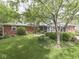 Lush backyard view with a well-maintained brick house, covered patio, and barbecue grill, perfect for outdoor living at 31 N Restin Rd, Greenwood, IN 46142