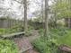 Scenic backyard with lush greenery, a wooden fence, and cozy benches creating a peaceful outdoor retreat at 31 N Restin Rd, Greenwood, IN 46142