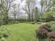 Lush backyard with mature trees, manicured landscaping, and a well-maintained lawn creating a serene outdoor space at 31 N Restin Rd, Greenwood, IN 46142