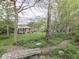 Picturesque backyard with a landscaped garden, mature trees, and a cozy bench for relaxation at 31 N Restin Rd, Greenwood, IN 46142