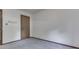 This bedroom features neutral carpeting, a wood door, and blank walls, creating a clean and simple space at 31 N Restin Rd, Greenwood, IN 46142