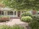 Inviting entrance showcases a brick walkway and covered porch with decorative plants at 31 N Restin Rd, Greenwood, IN 46142
