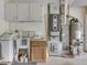 Garage interior featuring utility sink, white cabinets, modern water heater and HVAC unit in a clean and functional space at 31 N Restin Rd, Greenwood, IN 46142