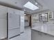 Well-lit kitchen featuring skylight, white cabinetry, and stainless steel appliances at 31 N Restin Rd, Greenwood, IN 46142