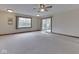 Open-concept living room with neutral carpet, natural light, and a sliding patio door at 31 N Restin Rd, Greenwood, IN 46142