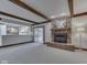 Cozy living room with exposed beams, brick fireplace, and open access to the kitchen at 31 N Restin Rd, Greenwood, IN 46142