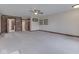 Bright living room with neutral carpet, ceiling fan, brick accents, and doorway access at 31 N Restin Rd, Greenwood, IN 46142