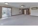 Expansive living area featuring neutral carpeting, sliding glass doors, and natural lighting at 31 N Restin Rd, Greenwood, IN 46142