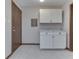 Bright mud room featuring white shaker cabinets, marble countertop, and gray vinyl flooring at 31 N Restin Rd, Greenwood, IN 46142